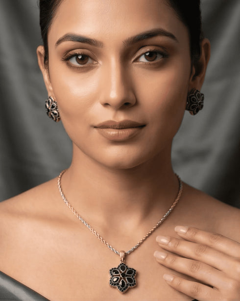 Elegant model wearing the signature midnight black pendant necklace and matching stud earrings for a formal evening look.