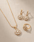Gold polish zircon jewelry set with necklace, earrings and ring on linen background – Jewels by Sarah