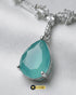 Close-up of the mint green teardrop pendant showing faceted stone detail and silver zircon setting.