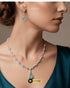 Model wearing the mint green signature necklace set with a dark teal outfit, showcasing the elegant jewelry drop.