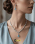 Model showcasing the mint green zircon necklace and matching earrings against a light grey formal dress.