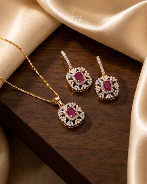 Gold ruby zircon pendant and dangle earrings set on wooden surface – Jewels by Sarah