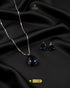Royal blue faceted teardrop pendant set with silver chain.