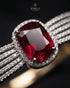 Close-up of ruby red center stone with pave zircon halo – Jewels by Sarah
