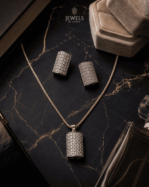 Gold jurao zircon pendant and earrings set displayed on marble – Jewels by Sarah