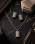 Gold jurao zircon pendant and earrings set displayed on marble – Jewels by Sarah