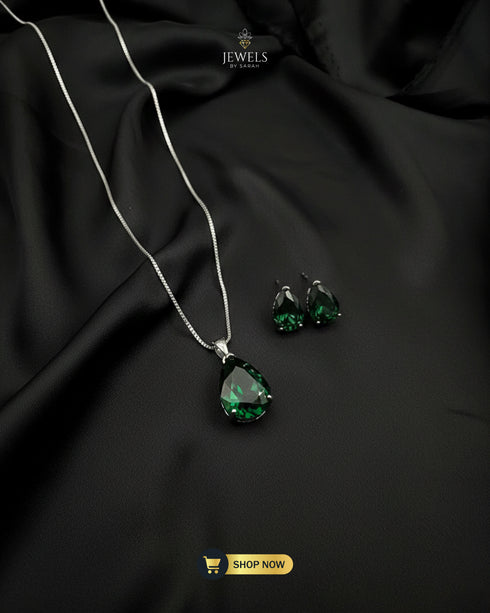 Emerald green teardrop stone pendant and earrings for formal wear.