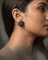 High-resolution profile shot showcasing the luxury midnight black floral stud earring.