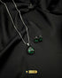 Emerald green teardrop stone pendant and earrings for formal wear.