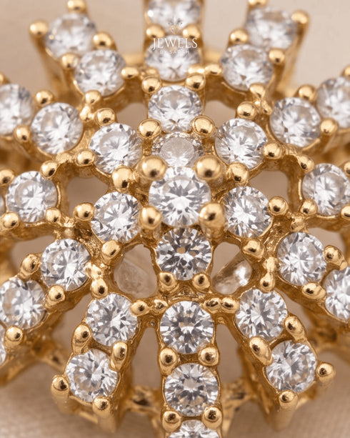 Close-up of sparkling zircon starburst design on gold-tone jewelry by Jewels by Sarah"