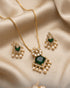 South Indian emerald square necklace and earrings set on beige satin fabric - Jewels by Sarah