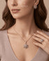 "Model wearing snowflake zircon necklace, earrings and ring styled with mauve top"