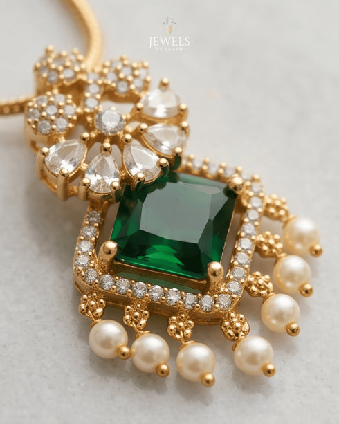 Close-up of square-cut emerald pendant with AD stones and pearl drops in 22K gold polish - Jewels by Sarah Signature Collection