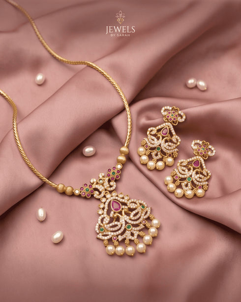 South Indian kemp peacock necklace set with matching earrings styled on pink satin - Jewels by Sarah
