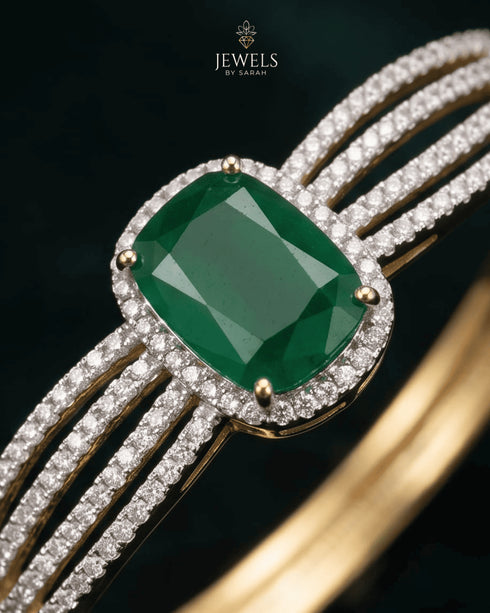 Close-up of emerald green center stone with pave zircon halo – Jewels by Sarah