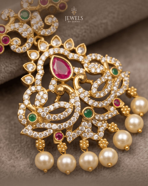 Macro detail shot of South Indian peacock pendant with ruby and emerald kemp stones and AD pavé - Jewels by Sarah