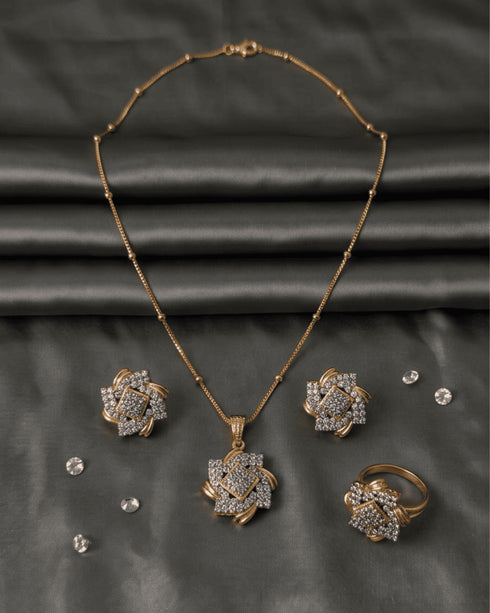 Premium AD diamond cut style jewelry set featuring a geometric floral pendant necklace, stud earrings, and ring on a grey satin background.