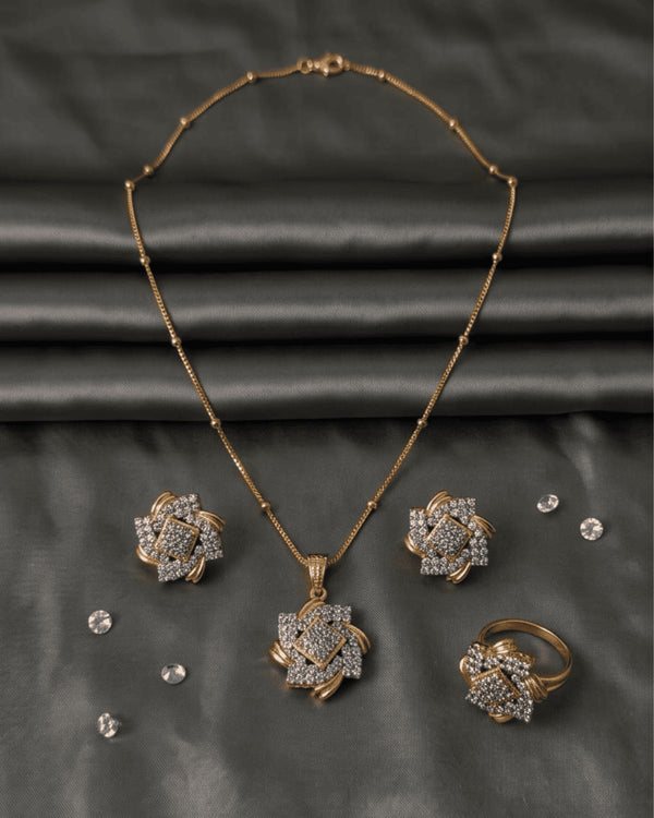 Premium AD diamond cut style jewelry set featuring a geometric floral pendant necklace, stud earrings, and ring on a grey satin background.