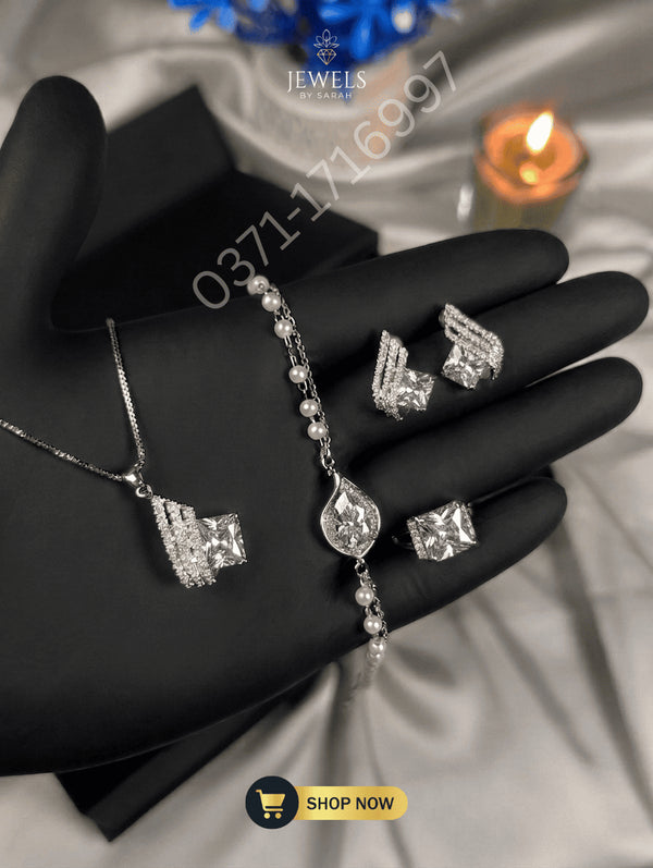 Silver-tone jewelry set with clear square zircon stones and pearl bracelet.