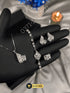 Silver-tone jewelry set with clear square zircon stones and pearl bracelet.