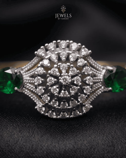 Close-up of zircon sunburst medallion with emerald accent stones – Jewels by Sarah