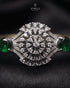 Close-up of zircon sunburst medallion with emerald accent stones – Jewels by Sarah