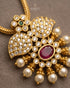 Close-up of ruby kemp stone pendant with AD stones and pearl drops in 22K gold polish - Jewels by Sarah