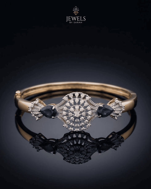 Gold sapphire sunburst medallion bangle bracelet on reflective black surface – Jewels by Sarah