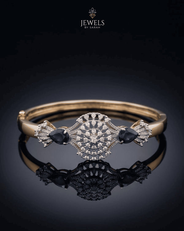 Gold sapphire sunburst medallion bangle bracelet on reflective black surface – Jewels by Sarah