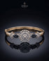 Gold sapphire sunburst medallion bangle bracelet on reflective black surface – Jewels by Sarah