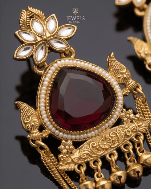 Close-up of maroon stone and peacock motif on Kashmiri style jhumka earring - Jewels by Sarah