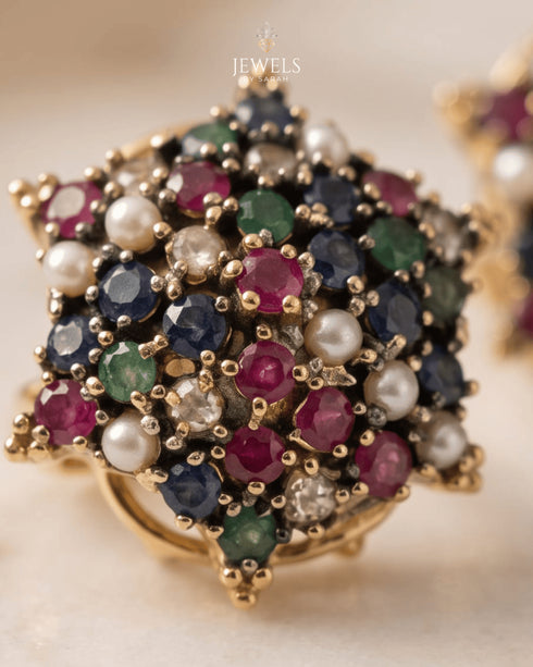 "Close-up of multicolor gemstone star cluster ring with ruby, sapphire, emerald and pearl stones by Jewels by Sarah"
