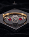 Gold ruby sunburst medallion bangle bracelet on reflective black surface – Jewels by Sarah
