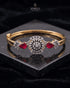 Gold ruby sunburst medallion bangle bracelet on reflective black surface – Jewels by Sarah