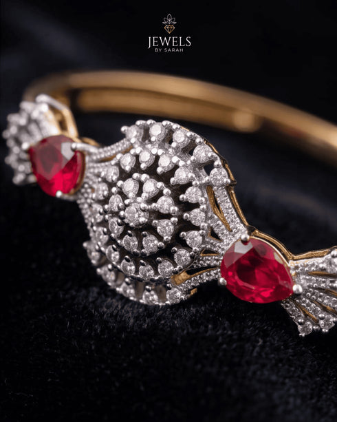 Close-up of zircon sunburst medallion with ruby red accent stones – Jewels by Sarah
