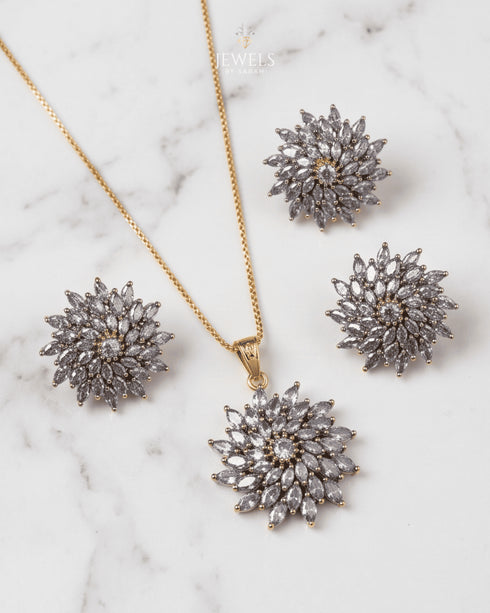 Marble background shot of jurao stone starburst pendant and matching earrings - Jewels by Sarah Signature Collection