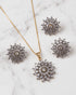 Marble background shot of jurao stone starburst pendant and matching earrings - Jewels by Sarah Signature Collection