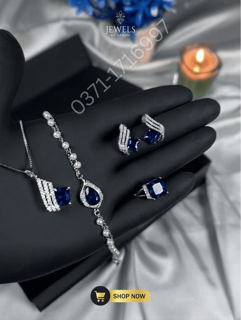 Royal blue stone jewelry set including necklace, earrings, and ring for women.