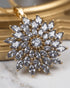 Close-up of marquise-cut jurao stone starburst pendant in 22K gold polish setting - Jewels by Sarah