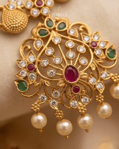 "Close-up of antique gold temple pendant with ruby, emerald and pearl detailing by Jewels by Sarah"