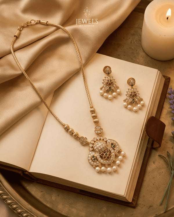 "South Indian heritage gold pearl drop necklace set with earrings styled with open book and candle by Jewels by Sarah"