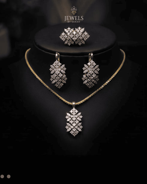 Gold diamond cut zircon leaf drop necklace and earrings styled on display bust – Jewels by Sarah