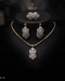 Gold diamond cut zircon leaf drop necklace and earrings styled on display bust – Jewels by Sarah