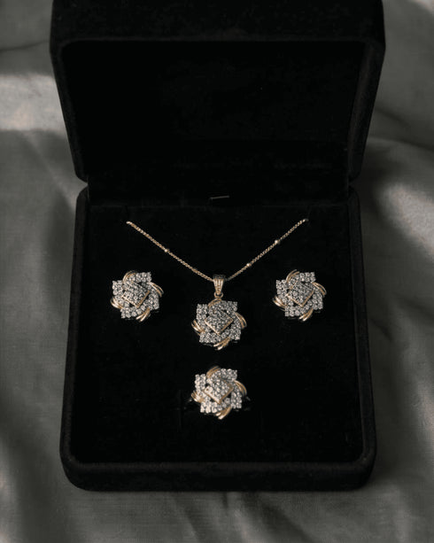 Original AD stone pendant necklace, earrings, and ring set in diamond cut style arranged inside a premium black velvet gift box.