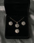 Original AD stone pendant necklace, earrings, and ring set in diamond cut style arranged inside a premium black velvet gift box.