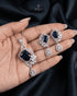Royal blue sapphire-toned emerald-cut artificial pendant set by Jewels by Sarah on luxury dark fabric.