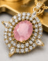 Close-up of pink centerstone and AD stone halo on Jadau pendant - Jewels by Sarah 22K gold polish