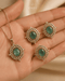 Green AD stone Jadau pendant set with matching rings held in hand - Jewels by Sarah Signature Collection