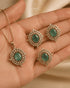Green AD stone Jadau pendant set with matching rings held in hand - Jewels by Sarah Signature Collection