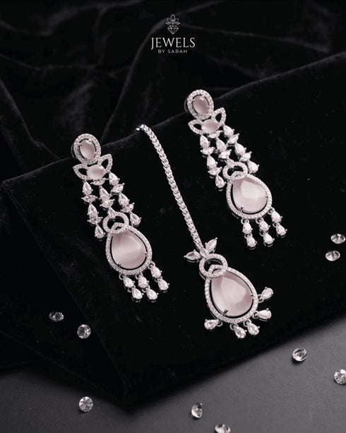 Close up of pink stone drop earrings and tikka with AD stone detailing